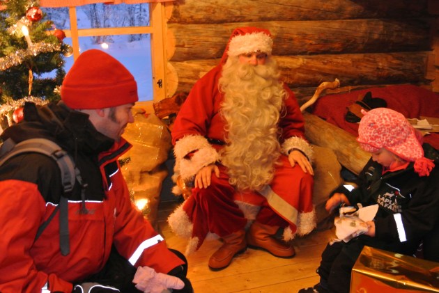 Santa Claus told her that she could open a gift from him. It was a game from the wish list she had handed him!