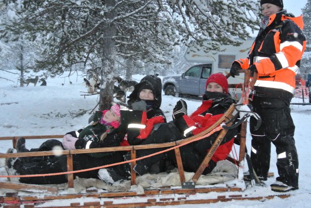 My family in the husky sledge, about to go dog sledding.