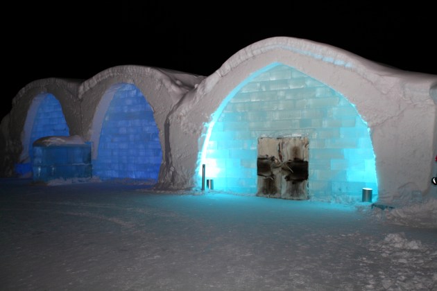 ICEHOTEL Sweden by night. The darker blue arches on the left are UNIQUE ICEBAR